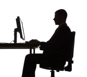 silhouette of man working computer